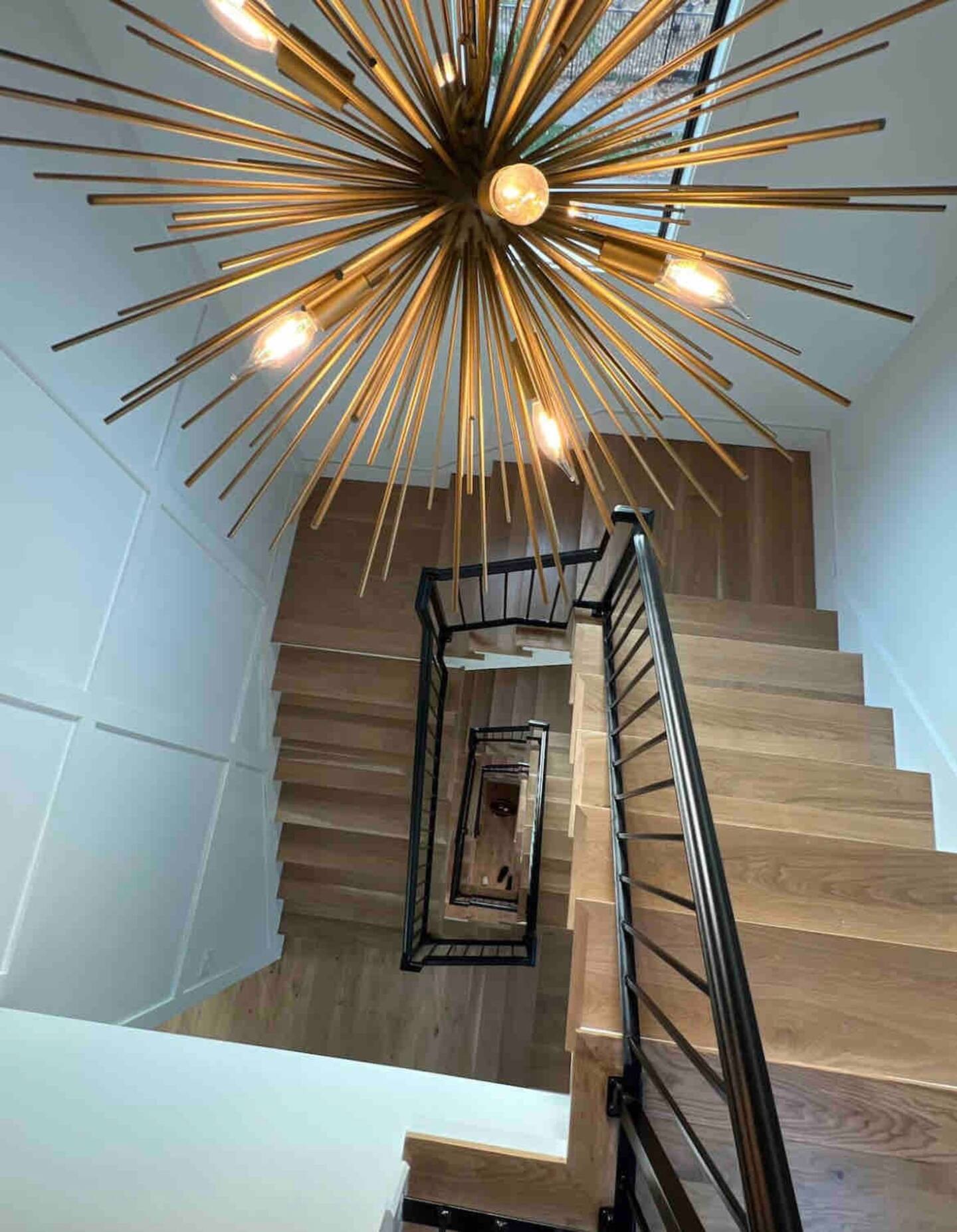 Staircase with sputnik light fixture